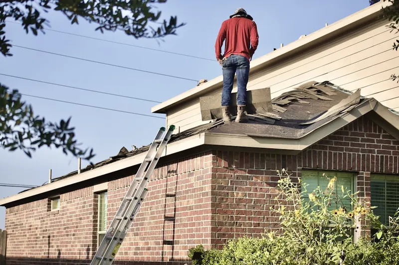 Professional roofer working on a residential roof in Windmill Springs